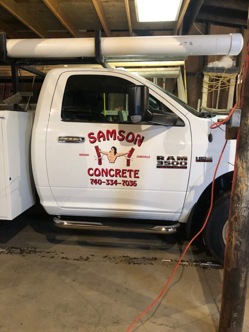 A white truck with the name samson concrete painted on it.